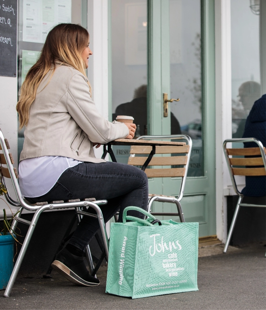 women sat outside with johns bag